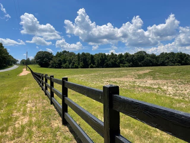 Concrete ranch rail fence with wood-grain texture in Florida